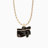 Necklace with a black stone pendant on a gold chain against a white background
